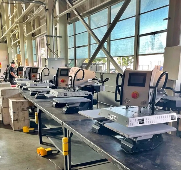 Assembly line of Insta 780 Automatic Heat Press machines in production facility, showcasing automatic heat press equipment manufacturing